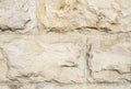 Stone wall of natural stones; Rustic stone veneer in shades of brown and beige