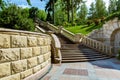 Stone wall near the marble staircase with balustrades. Royalty Free Stock Photo