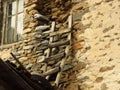 A stone wall of an old abandoned ruined house, window and a ladder. Royalty Free Stock Photo