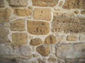 Stone wall of the old building, sand color, stone background.