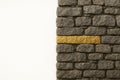 A stone wall with one golden brick that stands out. Space for text. Royalty Free Stock Photo
