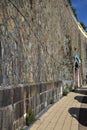 Stone wall and pavement on a sunny day Royalty Free Stock Photo