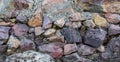 Stone wall. Pink granite and colored marble.