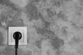 Wall with power socket and inserted plug, space for text. Electrical supply Royalty Free Stock Photo