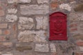 Stone wall with red mailbox