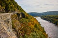 Stone wall and road wind through cliffs and mountains next to Delaware River in early fall Royalty Free Stock Photo