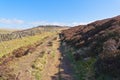 A drystone wall runs alongside the footpath to Higger Tor Royalty Free Stock Photo