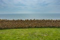 Stone wall separating green meadow from the horizon