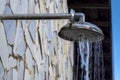 Stone wall with shower with falling water, outdoors in a swimming pool Royalty Free Stock Photo