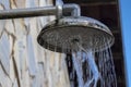 Stone wall with shower with falling water, outdoors in a swimming pool Royalty Free Stock Photo