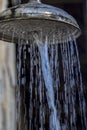 Stone wall with shower with falling water, outdoors in a swimming pool Royalty Free Stock Photo