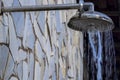 Stone wall with shower with falling water, outdoors in a swimming pool Royalty Free Stock Photo