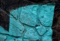Stone wall sprayed with colored sprays. it is vandalism, at the same time an interesting background of painted irregular stones co Royalty Free Stock Photo