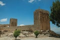 Stone wall and square tower from castle over rocky hill Royalty Free Stock Photo