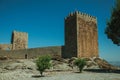 Stone wall and square tower from castle over rocky hill Royalty Free Stock Photo