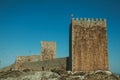 Stone wall and square tower from castle over rocky hill Royalty Free Stock Photo