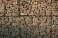 Stone wall. Stones behind the wire.