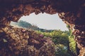 Stone wall in Taormina Isola Bella gardens. Opening in the wall with view to nature Royalty Free Stock Photo