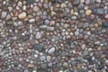 Stone wall texture, road made of small round stones Royalty Free Stock Photo