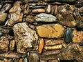 Stone wall texture. Water drips down the stone wall, texture background. Stone wall as background or texture. Part of a stone wall Royalty Free Stock Photo