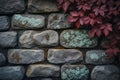 A stone wall covered with lichen and accented by a red vine Royalty Free Stock Photo