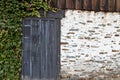 Stone wall with weathered door and ivy Royalty Free Stock Photo