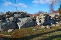 A stone wall in Westport Ma in need of repair with many rocks fallen to the ground