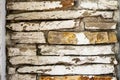 Stone Wall with White Plaster. Old stone wall with cracked white plaster and rustic structure close-up. Concept of vintage Royalty Free Stock Photo
