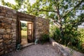 Stone wall, wooden doors opening, iron lion statues,outdoor entrance mediterranean villa