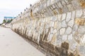 Stone walls block the waves on the beach Royalty Free Stock Photo