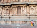 The stone walls with carvings of mythological deities at the ancient Hindu temple of