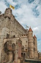 Stone watch-tower, walls and flags inside the Gravensteen Castle at Ghent.