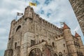 Stone watch-tower, walls and flags inside the Gravensteen Castle at Ghent.