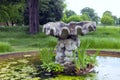 Stone water feature in a large pond Royalty Free Stock Photo