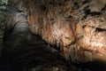 Stone waterfall rock formation and stalactites inside the cave