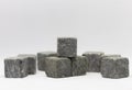 Stone whiskey cubes. A collection of grey, textured stone cubes arranged randomly against a white background. The cubes Royalty Free Stock Photo