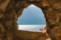 Stone window overlooking scenic landscape Garda lake