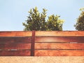 Stone and wooden fence and tree in Rishon Le Zion. Close up shot Royalty Free Stock Photo