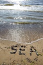 Stone word sea on summer beach Royalty Free Stock Photo