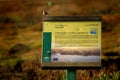 Stonechat sitting on the educaton board in Spanish Andalusia