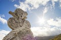 Stoned sculpture of cyclist on blue sky background. Tour de Fran