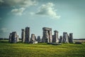 Stonehenge ancient ruins on Sailbury Plain in the UK standing under strange turqoise sky with long shadows