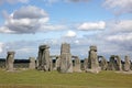 Stonehenge historic site on green grass under blue sky. Stonehenge is a UNESCO world heritage site in England with origins