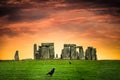 Stonehenge under colorful sunset with black crows Royalty Free Stock Photo