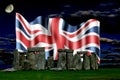 Stonehenge and the union flag at night