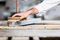 Stonemason applying water on stone plate before sawing