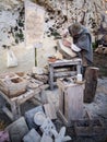 Stonemason carves and shapes the stone with a wooden hammer and chisel Royalty Free Stock Photo