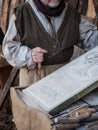 Stonemason carves the stone with a wooden hammer and chisel Royalty Free Stock Photo