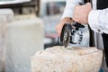 Stonemason cutting marble with angle grinder