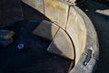 a stonemason repairs an old fountain. connects parts using